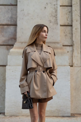 a lady wears a camel wool cropped trench coat with belt